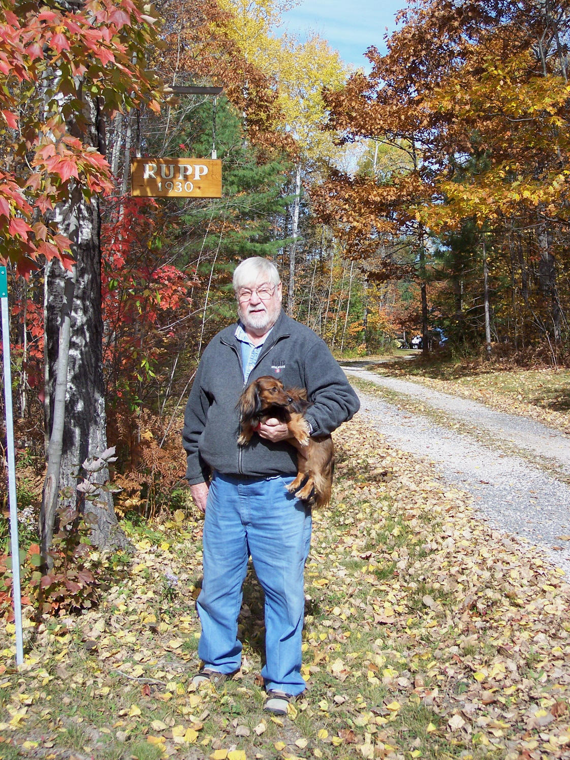 Allen M. Rupp and Daisy in Front of Sign to Driveway